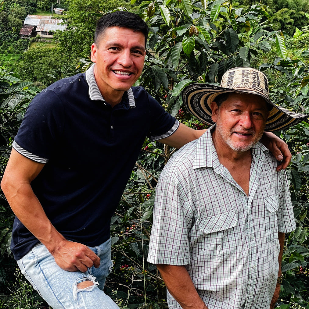 Jaime and his son, Jaime Andrés Casallas, standing next to coffee trees.